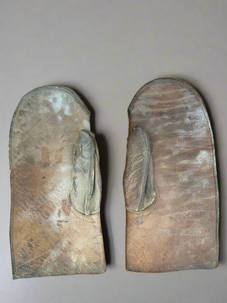 Antique brown leather oven mitts.