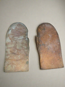 Antique brown leather oven mitts.