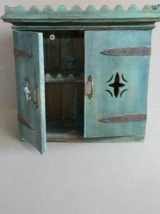 Scandinavian style wall cabinet with double doors. Aged teal painted patina and metal club shaped handles.