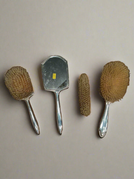 Victorian silver engraved four-piece brush and mirror vanity set.