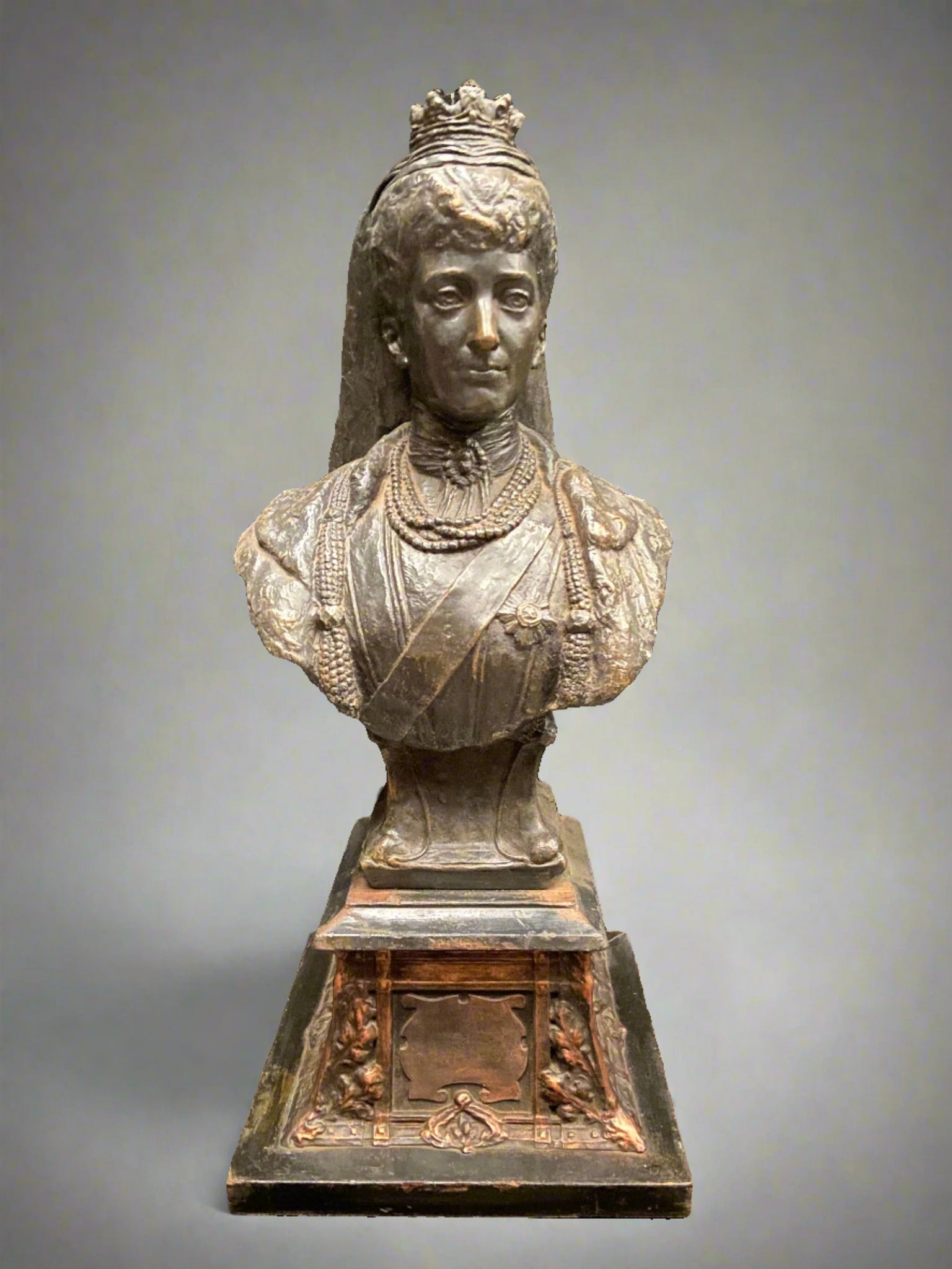 Cast bronze bust statue of Queen Alexandra of Denmark, sitting on a plinth.