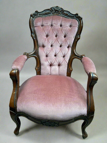 Antique dusty pink buttoned armchair with an ornately carved frame, standing on cabriole legs. Circa Mid Victorian.