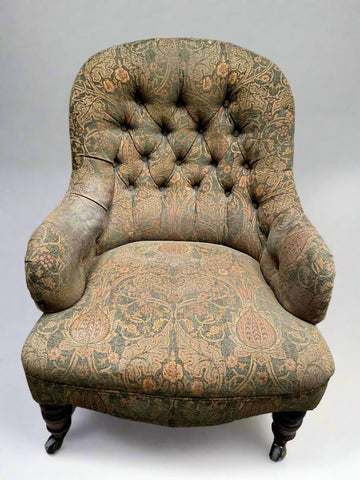 Antique floral William Morris-style buttoned armchair.