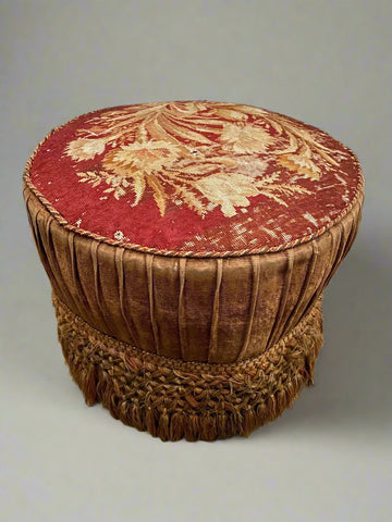 Antique needlework tapestry footstool stitched with pink and beige thread.