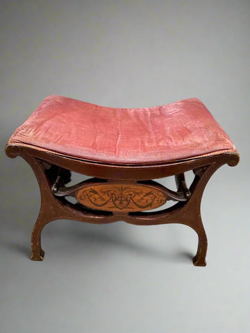 Victorian footstool/ window seat/ dressing table stool with a curved seat upholstered in pink fabric and painted decorative wooden panel.