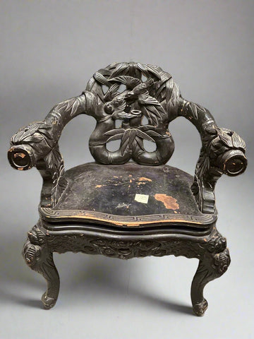 Unusual carved wooden armchair with a pretzel-shaped back and botanic detailing, sitting on cabriole legs. Typically called a Japanese emperor throne chair.