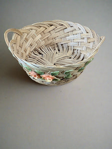Woven reed basket decorated with pink roses.