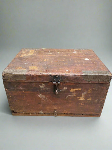 Heavily aged wooden trunk with metal hardware.