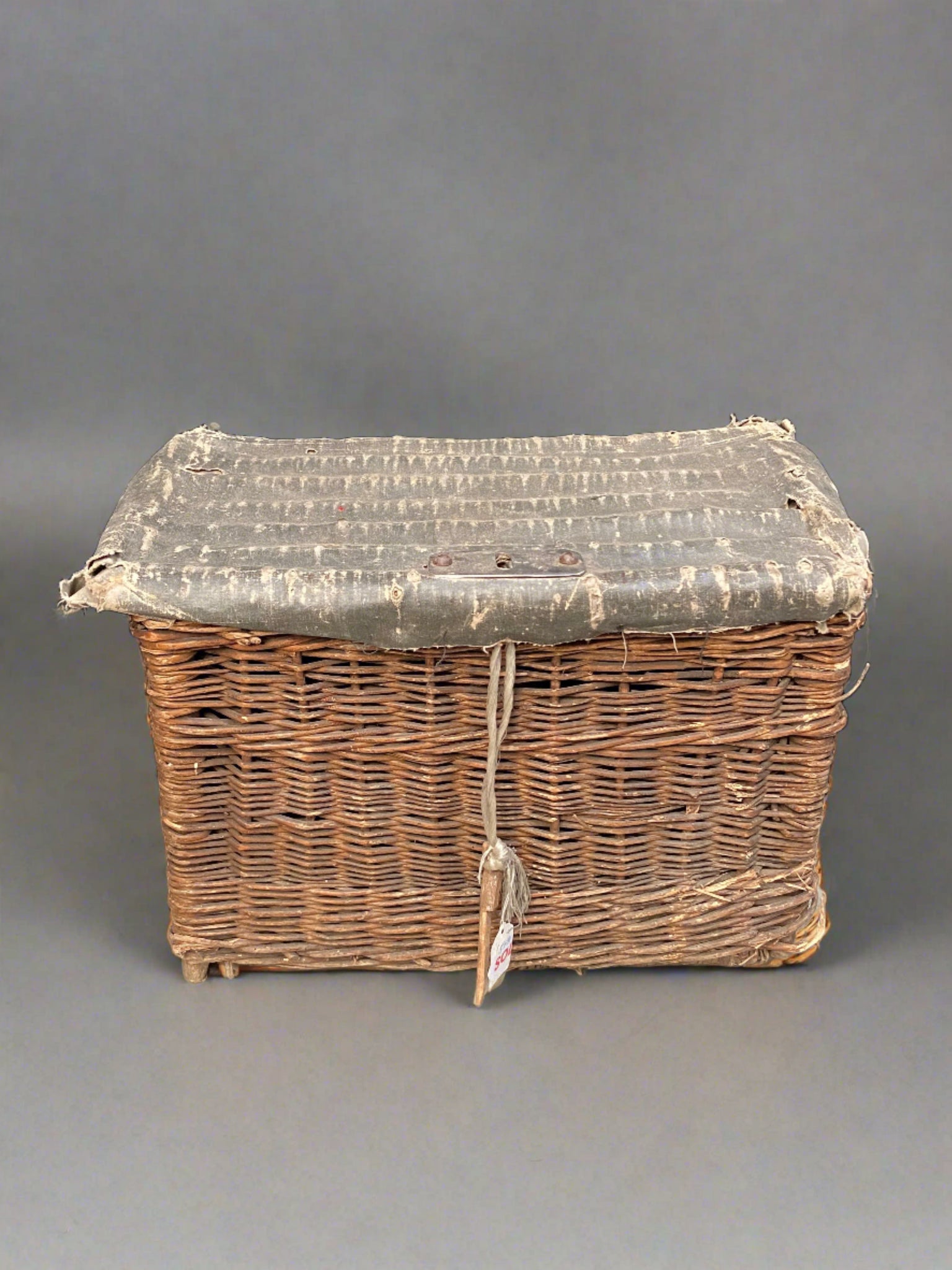 Small square wicker hamper with an aged green/grey oilcloth top.