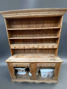 Large pine kitchen dresser with seven drawers and shelves for crockery display.