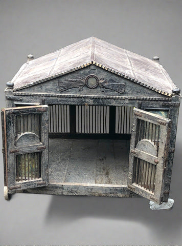 Large animal house/cage in the style of a mausoleum.