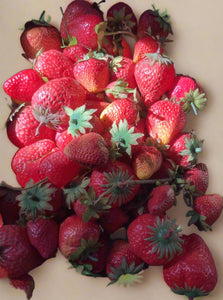 A bag of faux plastic strawberries, ideal for market or shop dressing.