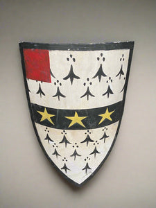 Lifesize prop-make shield hand-painted in black, white, red, and yellow paint.