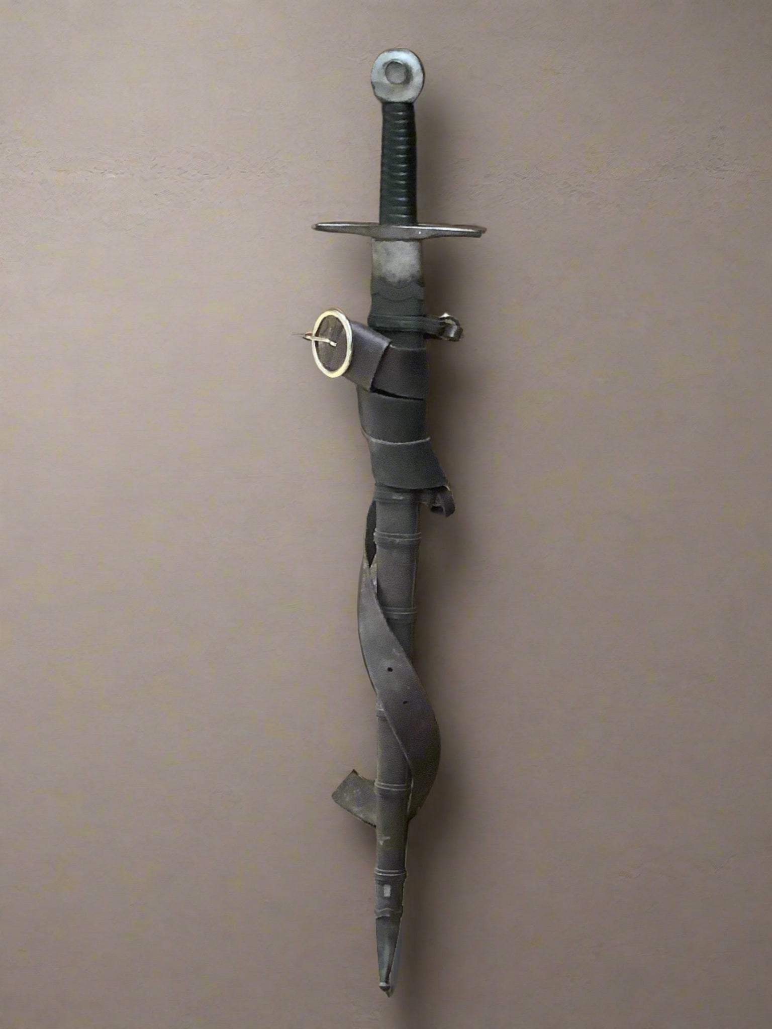 Prop rubber sword with a leather carrying strap.