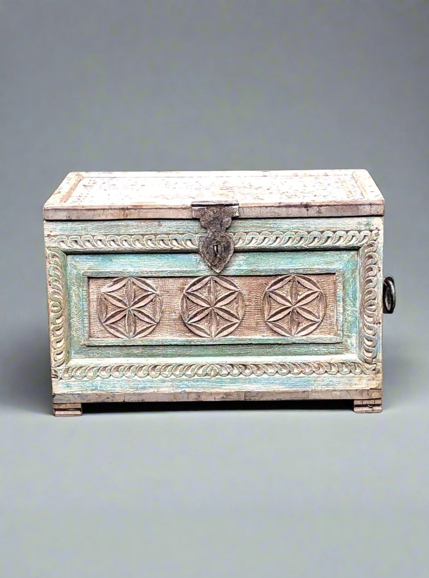 Carved rustic wooden coffer, featuring a green painted panel with lid and metal clasp.