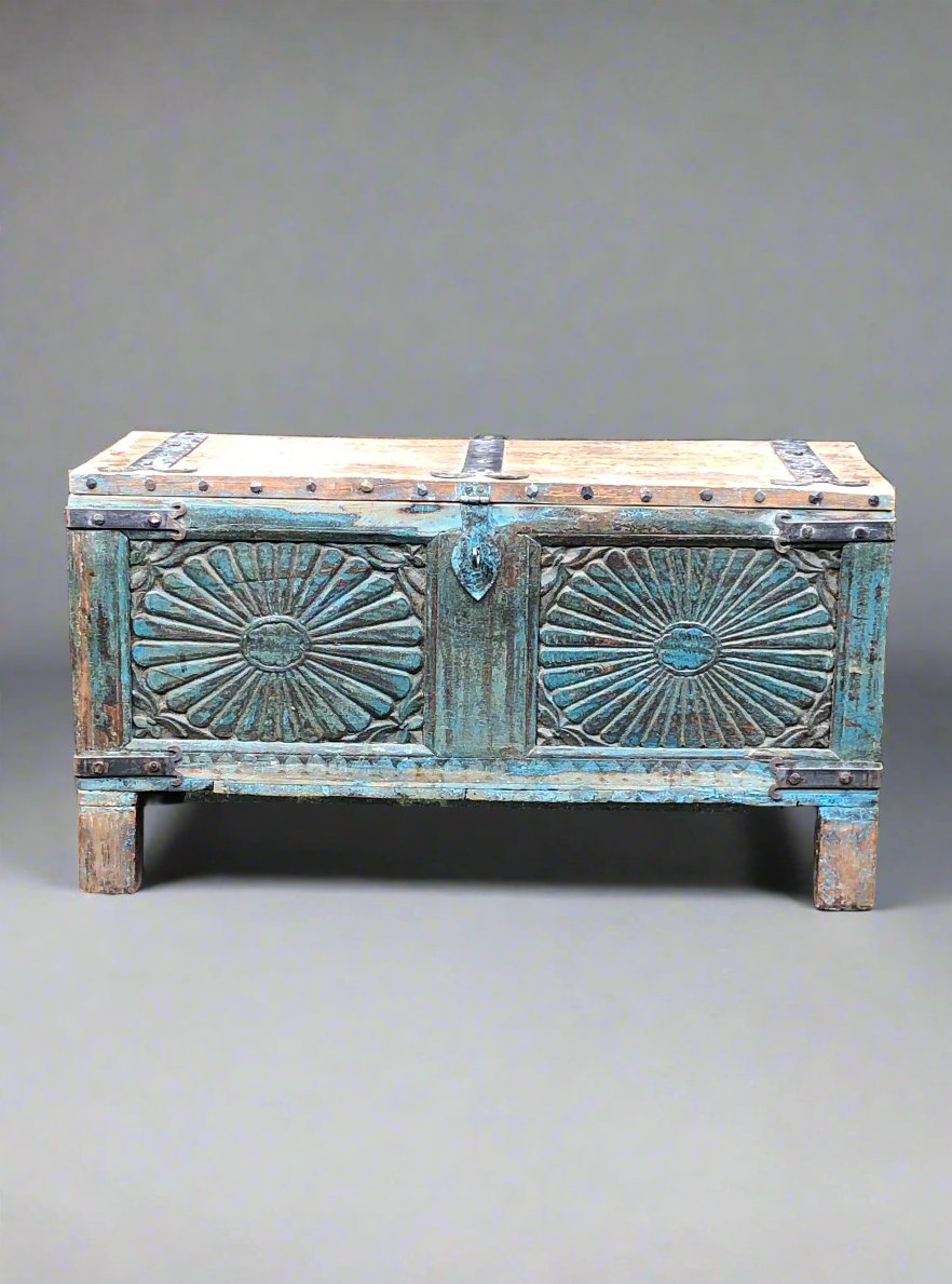 Carved rustic wooden coffer, featuring a blue painted panel with lid, metal clasp and banding.