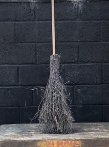 Rustic birch broom with a dowel handle.