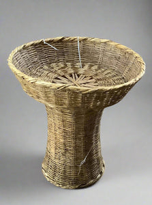 Woven rattan basket/plant stand in diablo silhouette.