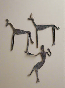 Set of three decorative hand-wrought iron motifs in the shape of a human figure and two mammals.