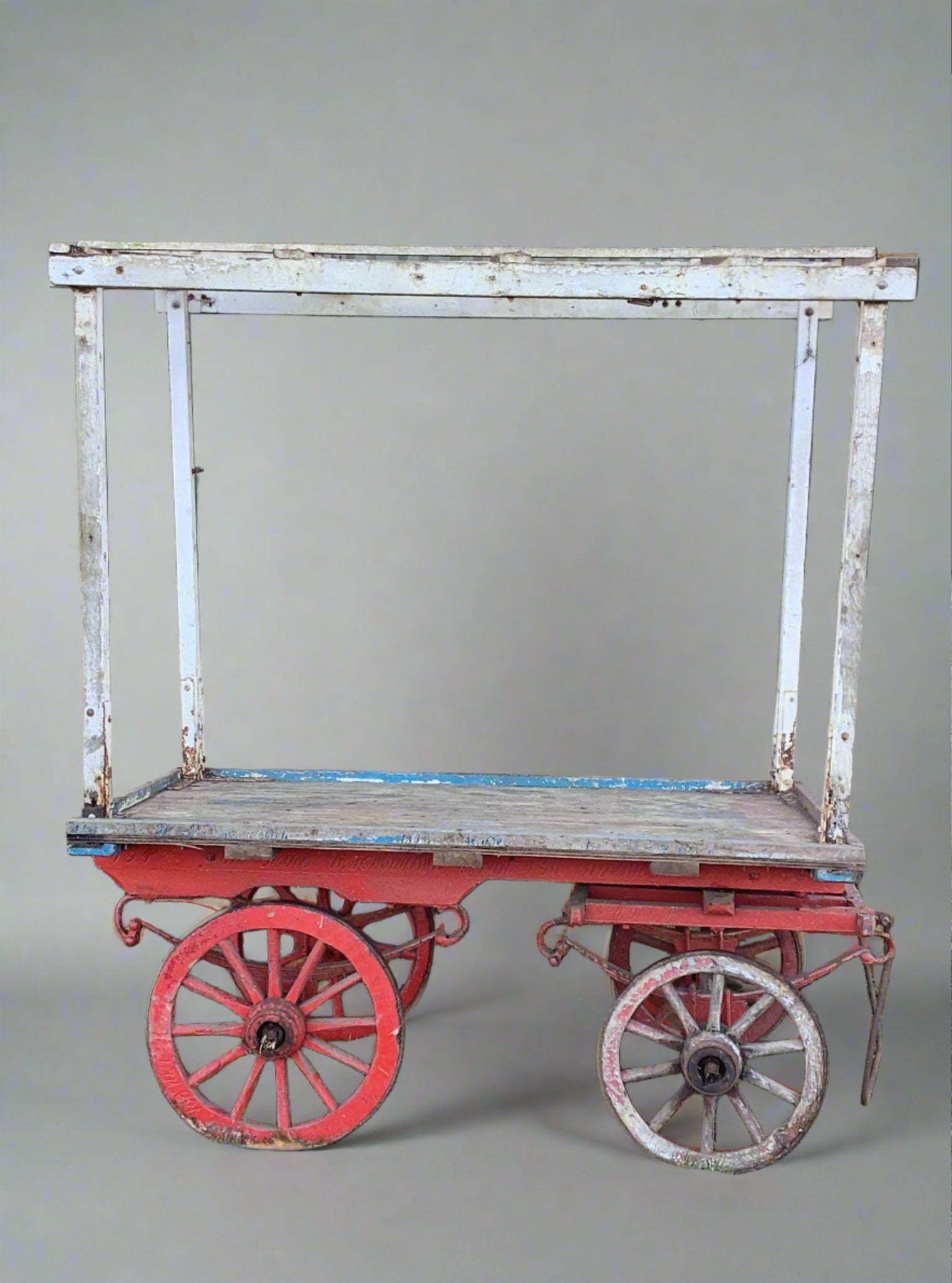 Colourful red and blue wooden market cart with roof.  Textile covering can be added to top section for a further splash of colour if required (as long as hirer ensures no damage is made to the cart.)