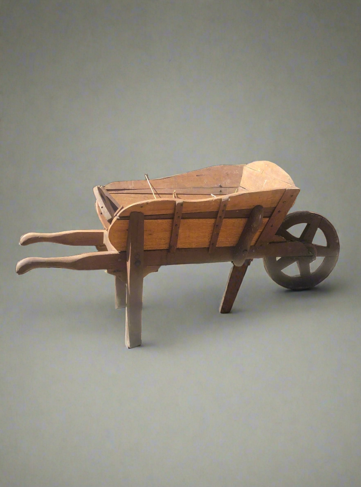 Antique rustic wooden wheelbarrow in two contrasting types of wood.