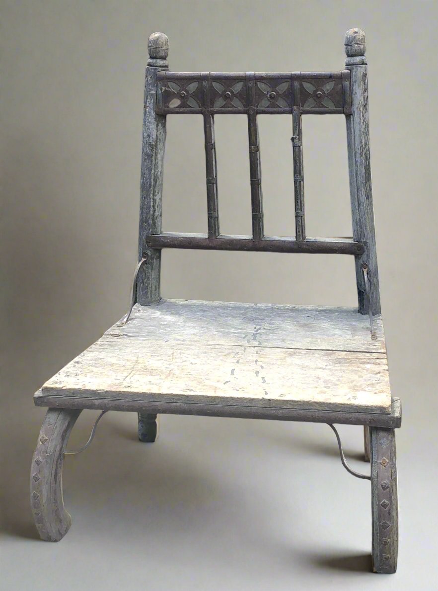 Wooden chair with carved detail to top of seat back and low seat feature. Intended for use as a nursing chair, but could be used for other functions.