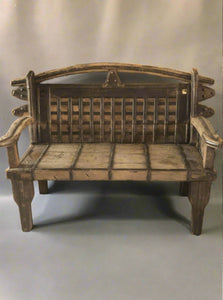 Medieval style wooden bench with unusual metal slatted panel to seat back, metal band trims and studding to legs.