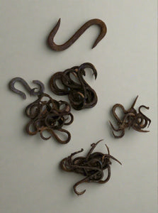 Hand wrought assortment of s-hooks in a variety of styles and thicknesses.