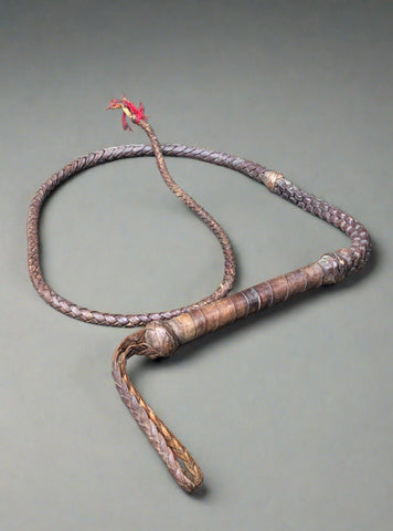 Brown leather plaited horsewhip with loop handle.