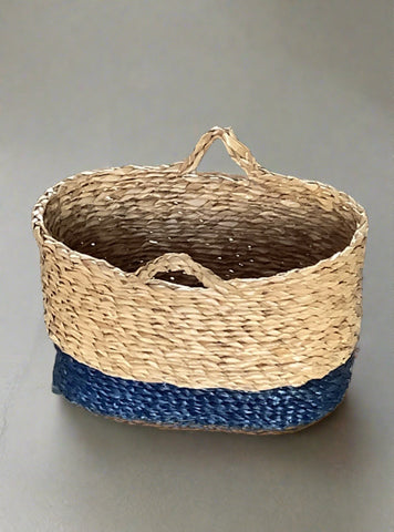 Small plaited basket with double handles and a blue stripe along the bottom.